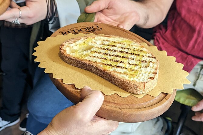 1.5 Hour Food Tour in Verona with Tastings and Sightseeing - Admiring the Roman Gavi Arch and Porta Borsari