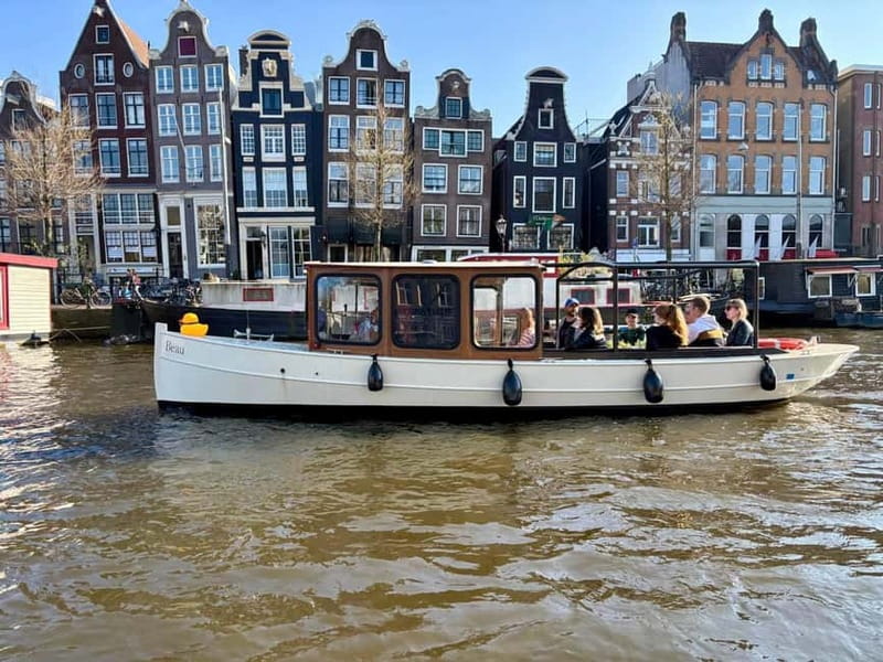 Amsterdam Canal Boat Tour with Live Guide - The Experience in Different Light Conditions: Day and Evening Cruises