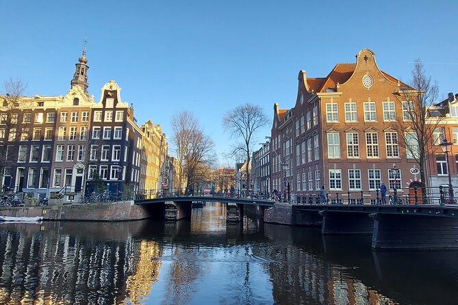Amsterdam Layover: Walking Tour & Canal Cruise + Airport Transfer - Walking Tour Through Dam Square and Beyond