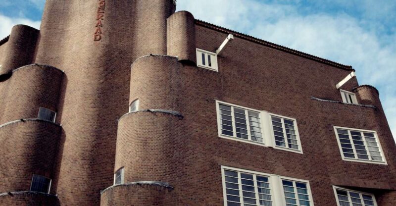 Amsterdam: Museum De Dageraad Entry Ticket with Guided Tour - Discovering the Building Behind the Wave-Shaped Facade