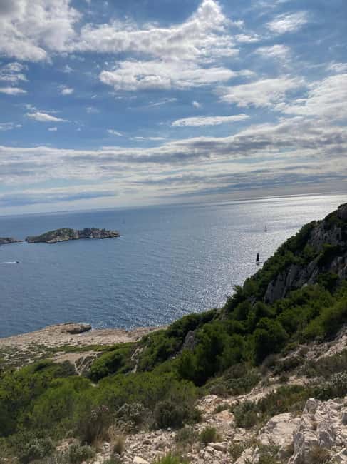 Calanques Ridge Trek with Panoramic Mediterranean Views - Descending Toward the Coastal Waters