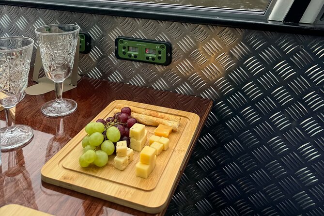 Cheese and Wine Canal Cruise through Historic Amsterdam - Landmark Stops: Amstel Church, Skinny Bridge, and the Hermitage