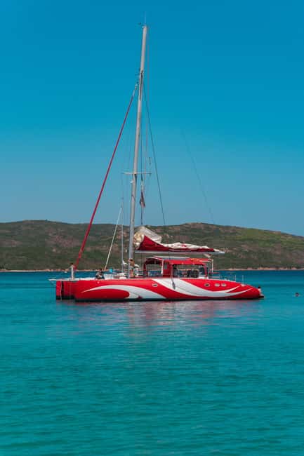 Cruising on a sailing maxi-catamaran - Starting Point and Access to Santa Giulia Beach