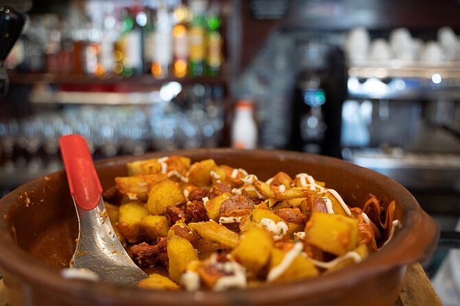 Evening in Madrid: Food on Foot Tapas Adventure with a Local - Sipping Local Liquor: Madroño and Other Treasures