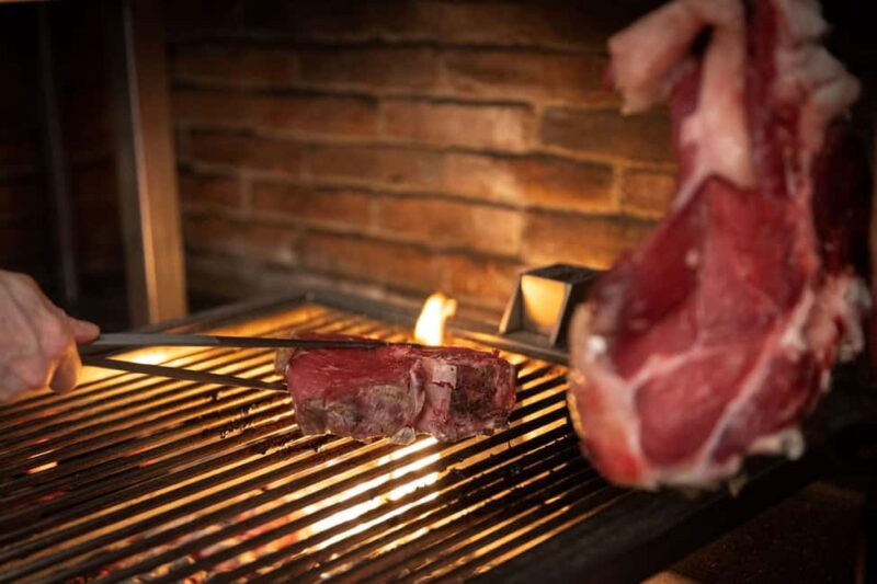 Florence: Live Grill Show & Steak Dinner with Wine - Florences Historic Restaurant with an Open-Fire Grill