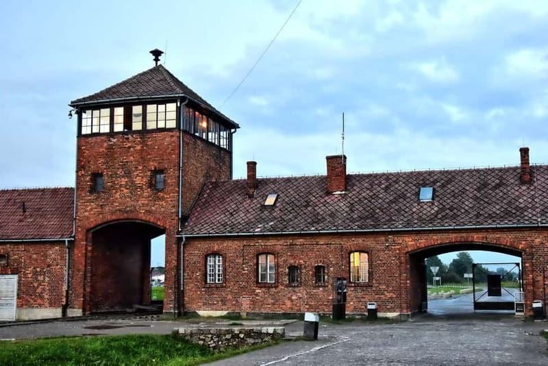 From Krakow: Auschwitz-Birkenau Guided Tour & Transportation - Exploring Auschwitz I: The Gate with "Arbeit macht frei"