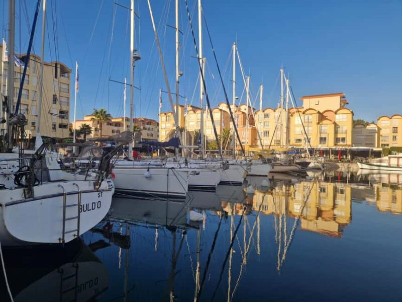 Gruissan: from the New Port to the Old Village - Exploring the Place des Mehnirs: The Heart of the Port