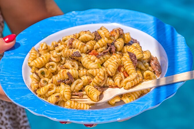 Guided day by boat in Carloforte with snorkelling and aperitif - Cala Mezzaluna: A Natural Amphitheater with Crystal Clear Waters