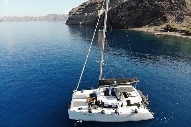 Half-Day Exclusive Catamaran Cruise in Santorini with Meal and Open Bar - Key Points