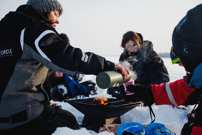 Ice Fishing and Snowmobile Safari Combo in Lapland - Warming Up with a Campfire BBQ and Hot Beverages