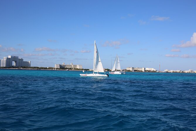 Isla Mujeres Catamaran Adventure Snorkeling Spinnaker and Lunch - Arrival at Isla Mujeres and the Beach Club Experience