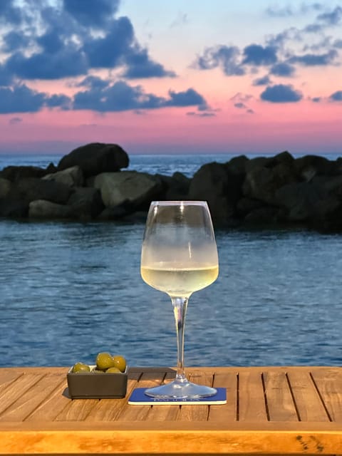 Italian aperitif at the sunset by the sea - Key Points