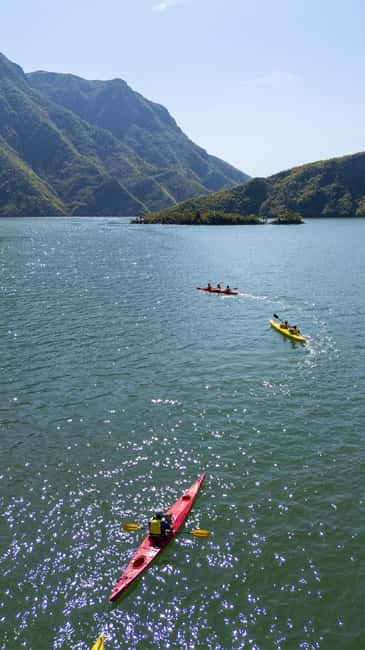 Koman Lake: Kayak Rental with Boat Transfer - Kayaking Along Koman Lakes Stunning Mountain Landscapes