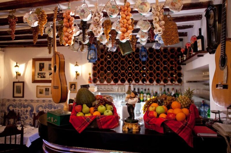 Lisbon: Alfama Charms, Tapas, Wine and Sunset Boat Cruise - Tasting Portuguese Tapas at a Local Tavern