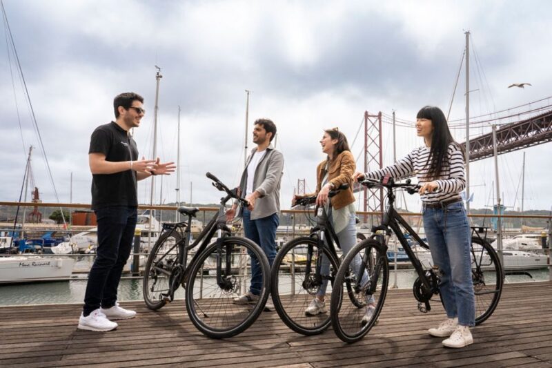 Lisbon: Guided Bike Tour, Helicopter Flight, and Boat Trip - Visiting Lisbon’s Historic Alfama District and Praça do Comércio