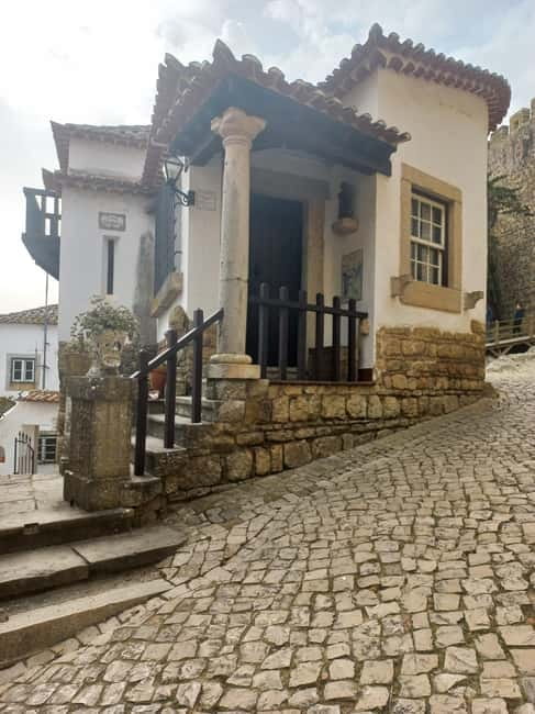 Lisbon: Transfer to Porto with Obidos and Nazare - Scenic Strolling Through Obidoss Medieval Walls and Castle