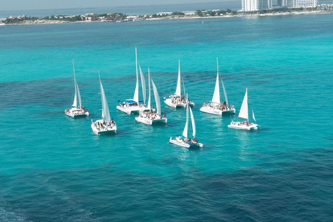 Live this unique experience. Catamaran to Isla Mujeres Tour. Open Bar included. - What Sets This Tour Apart