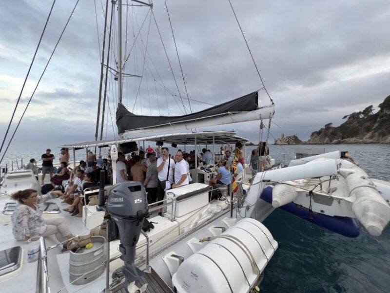 Lloret de Mar: Sunset Catamaran Cruise with DJ and Drinks - Swimming and Relaxing in a Secluded Inlet