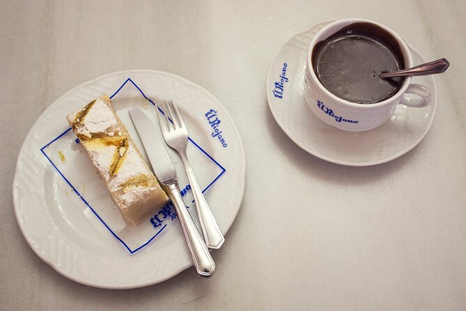 Madrid Walking Food Tour With Secret Food Tours - Sampling Iberian Ham and Manchego Cheese at a 180-Year-Old Deli