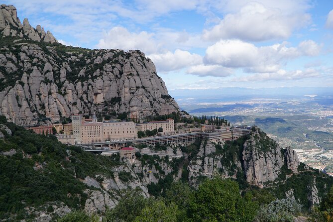 Montserrat Day Trip with Lunch and Wine Tasting from Barcelona - Exploring the Montserrat Monastery and Sacred Cave