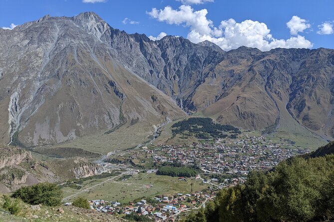 Private Full Day Trip to Kazbegi Mountains - Russian Georgian Friendship Monument: Daring Views from a Cliffside Balcony