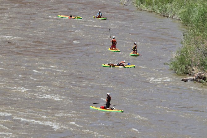 Rappelling and Stand Up Paddleboarding Combo - Transition from red rocks to water in the Colorado River