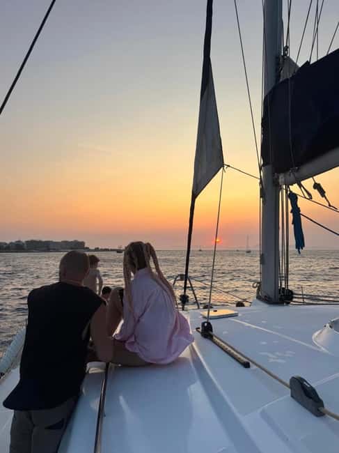 Rhodes: Sunset Catamaran Cruise with Snack, Fruits & Drinks - Swimming, Snorkeling, and Cave Exploration at Kallithea Springs Bay