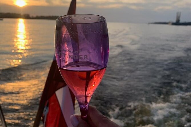 Riga: Evening or Sunset Boat Tour with Drink and Audio Guide - Choosing Between Sunset and Night Tours