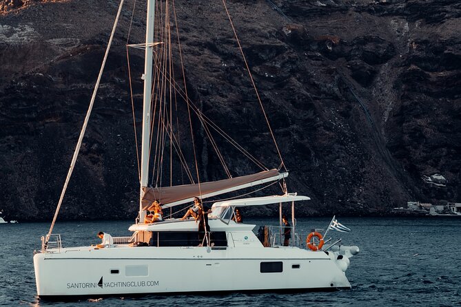 Romantic Sunset Catamaran Caldera Cruise incl. Meal & Drinks - Starting Point and Hotel Pickup Service in Santorini