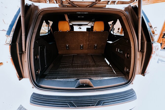 Roundtrip Deluxe Suburban Transportation - Meet Your Brightly Dressed Driver with Clear Signage