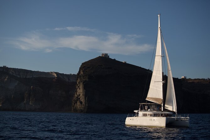 Santorini Caldera Gold Day Cruise with BBQ on board and Open Bar - The Scenic Passage Past the Lighthouse
