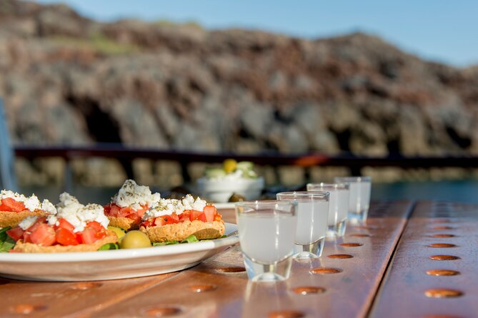 Santorini Caldera Sunset Traditional Cruise with Meal and Drinks - Visiting White Beach and Red Beach