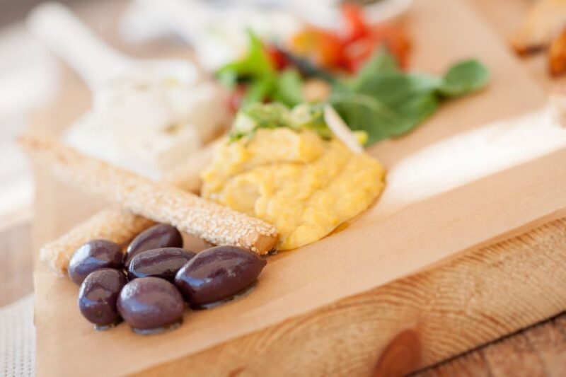 Santorini: Greek Food & Wine Tasting Tour - Savoring a Greek Meze Meal at a Local Restaurant