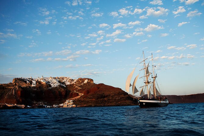 Santorini Sunset Dinner Cruise Including Nea Kameni Visit - Watching the Sunset Over Thirasia’s Rocky Coastline