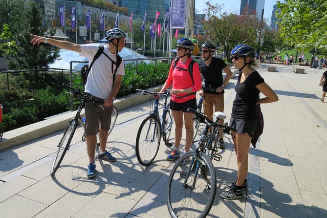 Stanley Park & Downtown - Vancouver Bike Tours - Iconic Vancouver Sights: Girl in a Wetsuit and Lions Gate Bridge