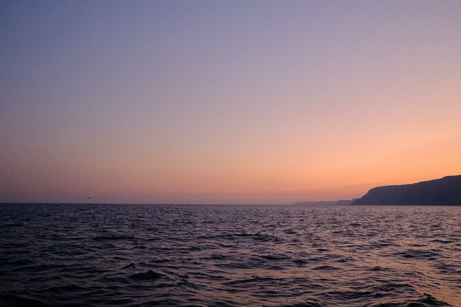Sunset on a sailboat in Arrábida, Setúbal - Witnessing the Sunset Over the Sea