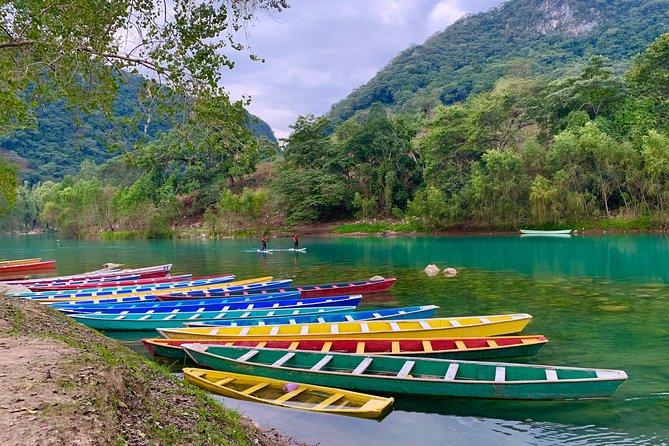 Tamul waterfall and water cave on a wooden canoe - Navigating the Tampaon River: Paddling and Scenic Views