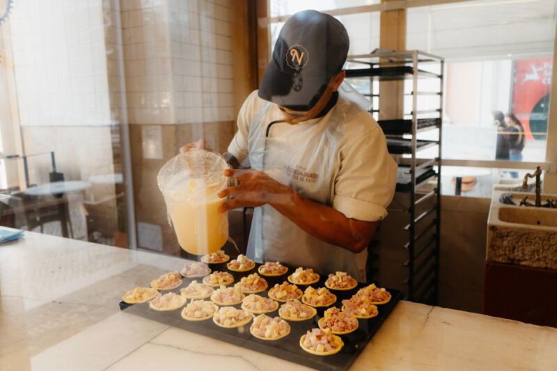The Heart of Lisbon Food Tour: Baixa, Chiado & Bairro Alto - Walking Through Bairro Alto and Savoring Grilled Fish
